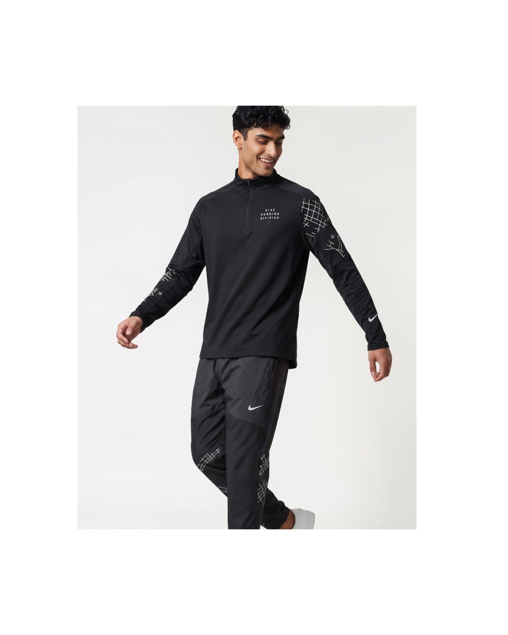 Plugmarket black running set with quarter zip top and pants. Features graphic print details and Nike swoosh.
