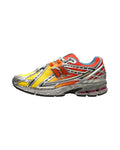 Plugmarket - New Balance 1906r sneakers in yellow, orange, and silver with a mesh upper and N logo.